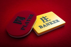 Baccarat rules -- bet on either the banker or the player