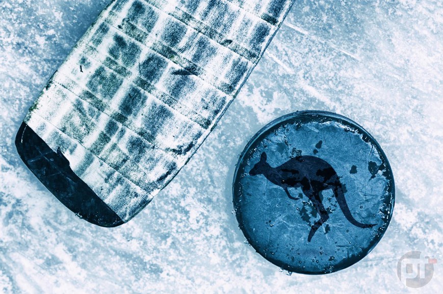 An overhead view of a hockey stick and puck on the ice. The puck has an image of a kangaroo on it. A historic NHL preseason game in Australia is coming up as the Arizona Coyotes and Los Angeles Kings face off in Melbourne.